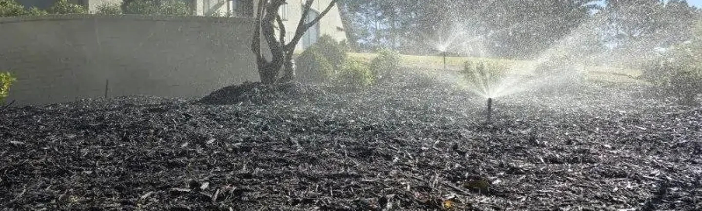 Sprinkler in a garden bed